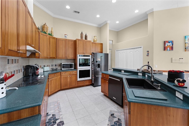 kitchen featuring a sink, dark countertops, visible vents, and stainless steel appliances