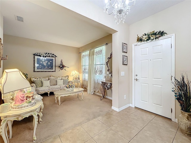 entryway featuring light tile patterned floors, visible vents, baseboards, light colored carpet, and a notable chandelier