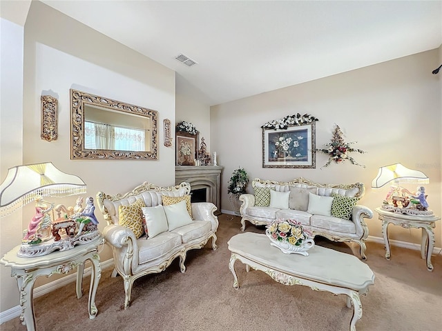 carpeted living room with a fireplace, visible vents, and baseboards