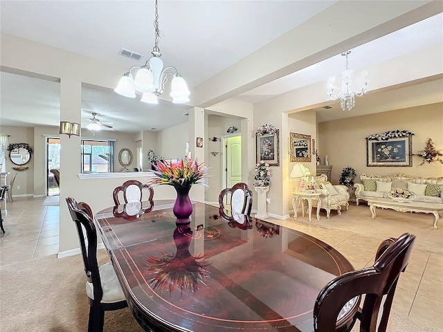 dining room with baseboards, visible vents, light colored carpet, light tile patterned flooring, and ceiling fan with notable chandelier