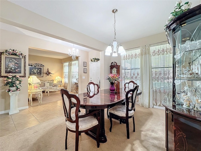 dining area with baseboards, light colored carpet, an inviting chandelier, and light tile patterned floors