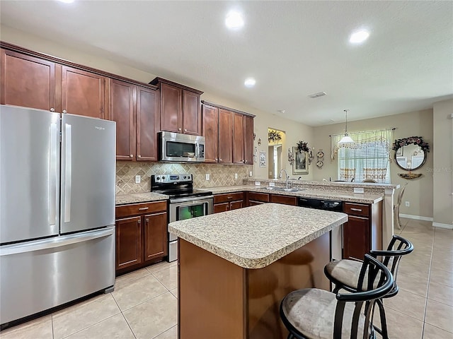 kitchen with a peninsula, stainless steel appliances, light countertops, a sink, and light tile patterned flooring