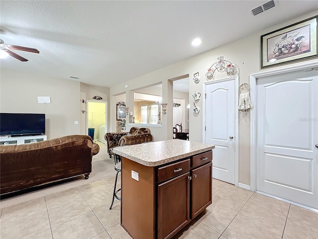 kitchen with open floor plan, light tile patterned flooring, and visible vents