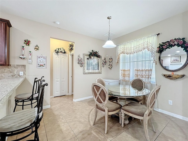 dining space with light tile patterned floors and baseboards