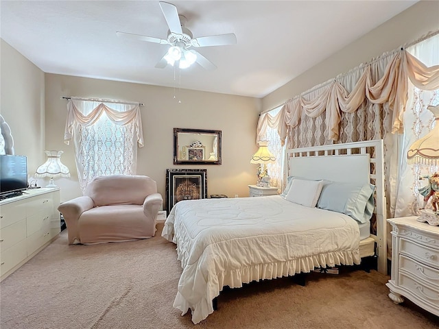 carpeted bedroom featuring ceiling fan