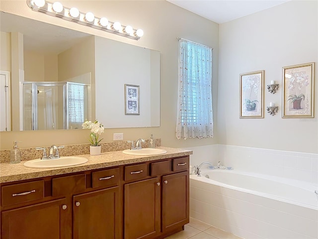 full bath with double vanity, a stall shower, a garden tub, and a sink