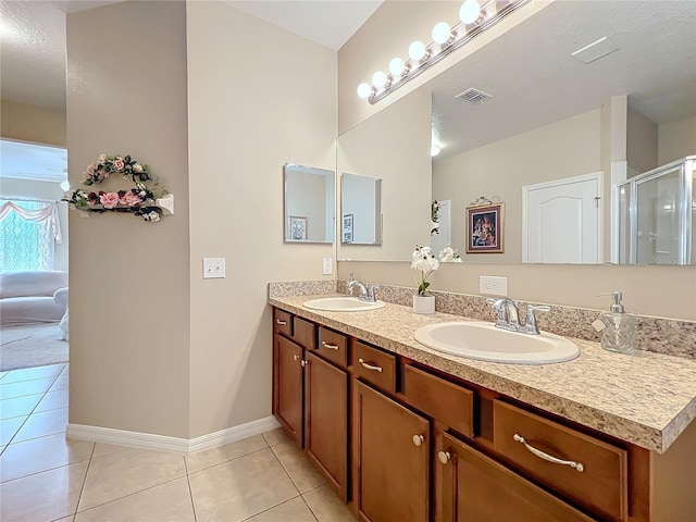 full bath with baseboards, a sink, and tile patterned floors