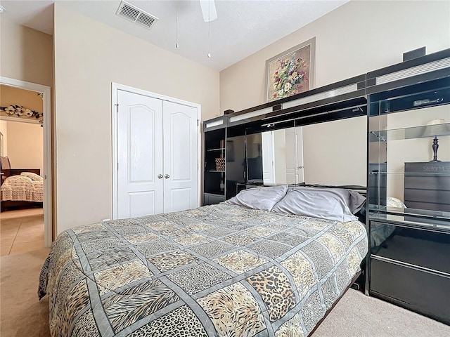 bedroom featuring carpet, a closet, visible vents, and tile patterned floors