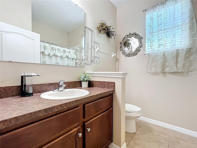 bathroom featuring baseboards, toilet, a shower with curtain, tile patterned floors, and vanity