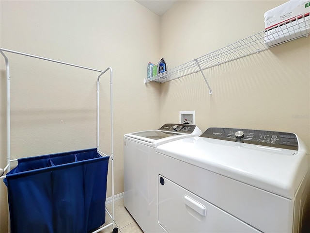 laundry room with light tile patterned floors, laundry area, and separate washer and dryer