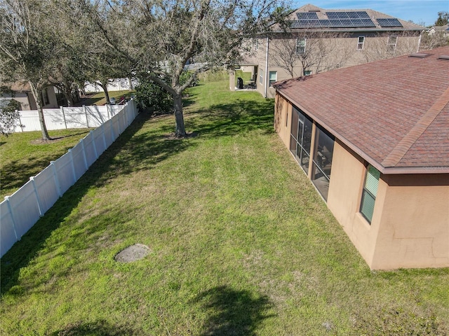 view of yard featuring a fenced backyard and a sunroom