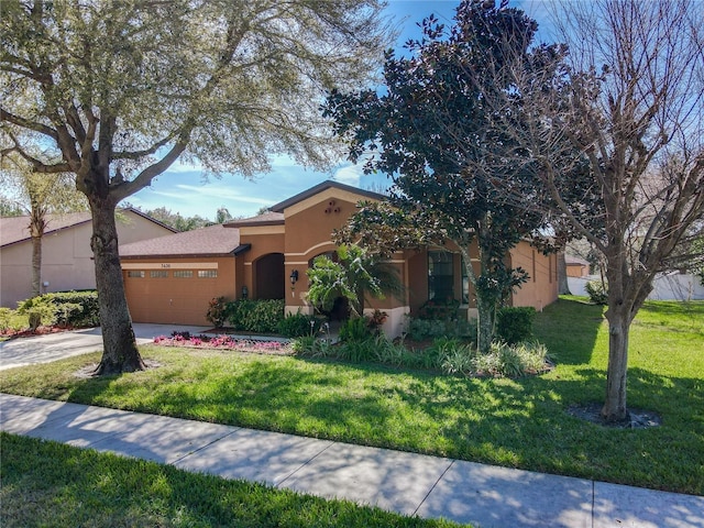 view of front of property with a garage, a front yard, driveway, and stucco siding