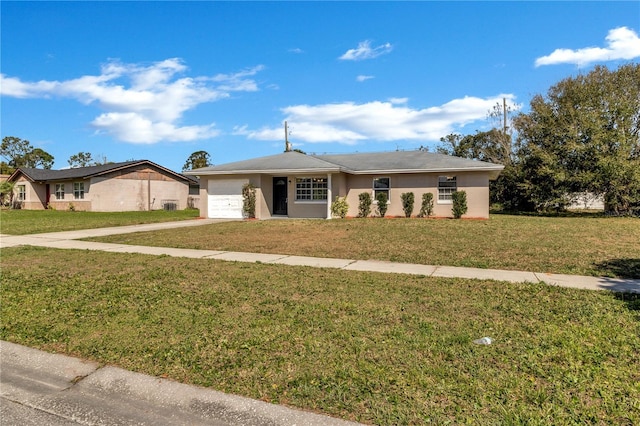 ranch-style home featuring a garage, a front lawn, concrete driveway, and stucco siding