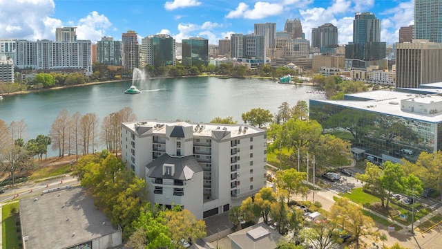 birds eye view of property featuring a city view and a water view