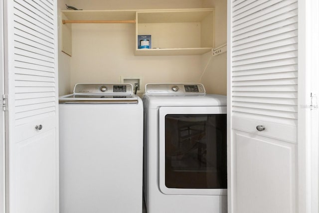 clothes washing area featuring washing machine and dryer and laundry area