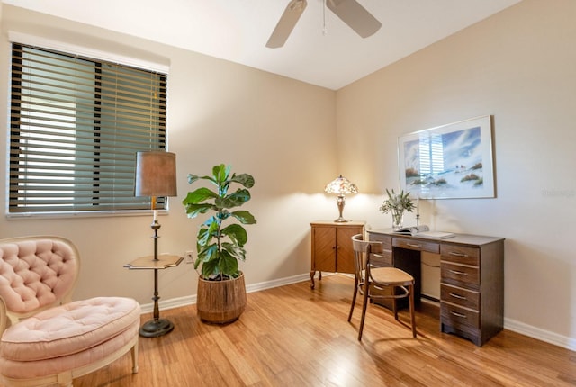 office space with a ceiling fan, wood finished floors, and baseboards