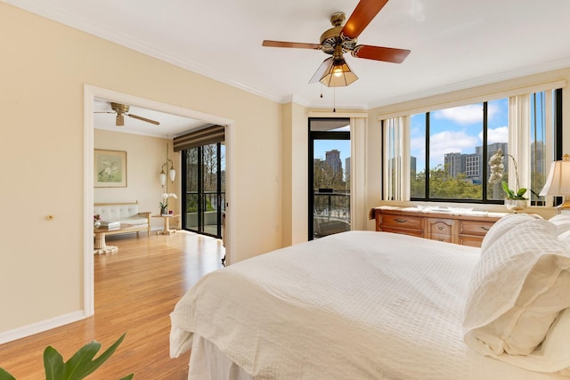 bedroom with crown molding, multiple windows, access to exterior, and light wood finished floors