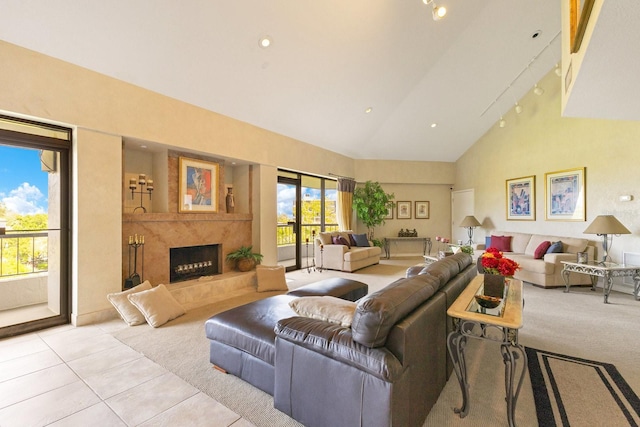 living room featuring light tile patterned floors, recessed lighting, a fireplace, rail lighting, and high vaulted ceiling