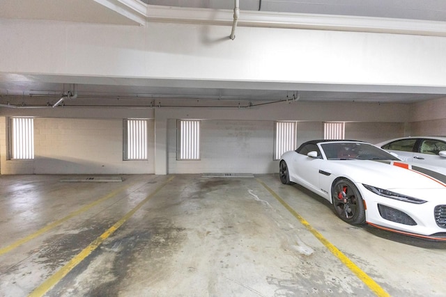 parking garage featuring concrete block wall