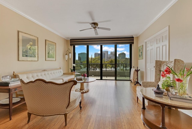 living room featuring ceiling fan, wood finished floors, ornamental molding, and a view of city