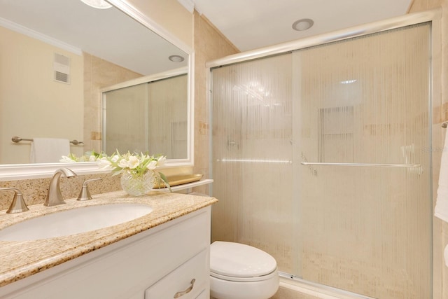 full bathroom featuring vanity, toilet, visible vents, and a stall shower