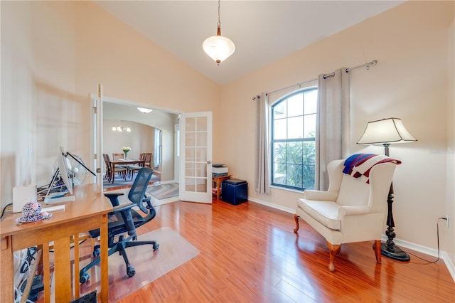 office space featuring french doors, baseboards, wood finished floors, and vaulted ceiling