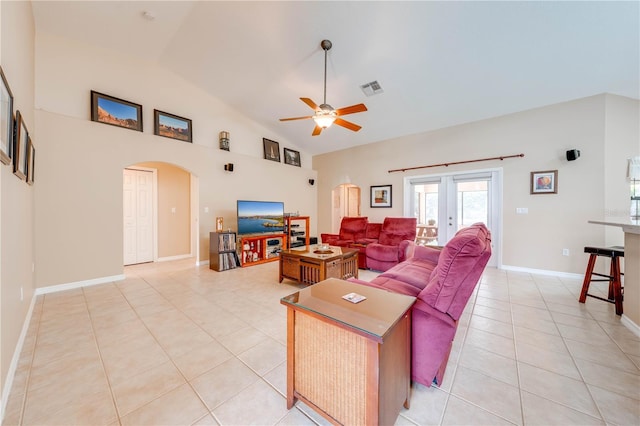 living room featuring visible vents, high vaulted ceiling, a ceiling fan, arched walkways, and light tile patterned floors