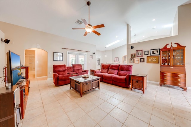 living area with visible vents, high vaulted ceiling, a ceiling fan, arched walkways, and light tile patterned flooring