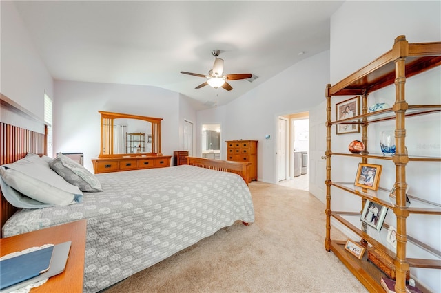 bedroom with lofted ceiling, washer / dryer, ceiling fan, carpet flooring, and connected bathroom