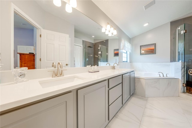 bathroom featuring visible vents, a stall shower, lofted ceiling, and a sink