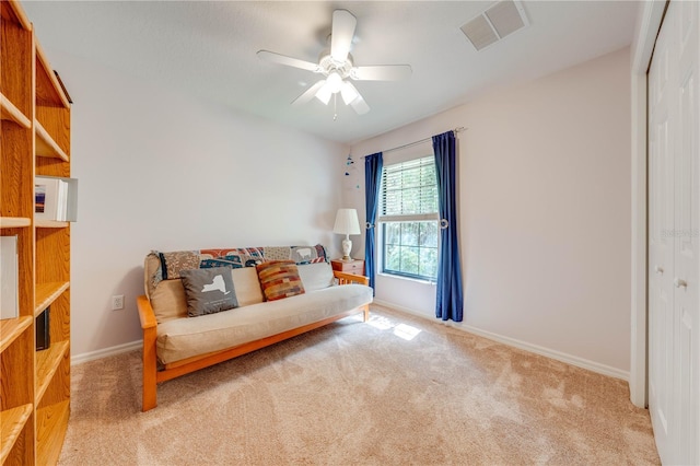 living area featuring visible vents, carpet flooring, baseboards, and ceiling fan