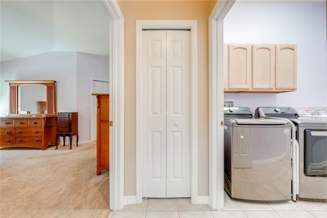 laundry room with baseboards, washing machine and dryer, light tile patterned floors, light carpet, and cabinet space