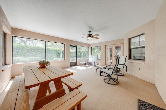 sunroom featuring ceiling fan