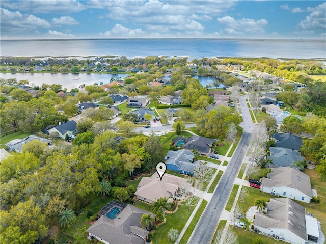 birds eye view of property with a residential view and a water view