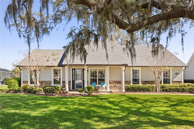 view of front of home with stone siding and a front yard