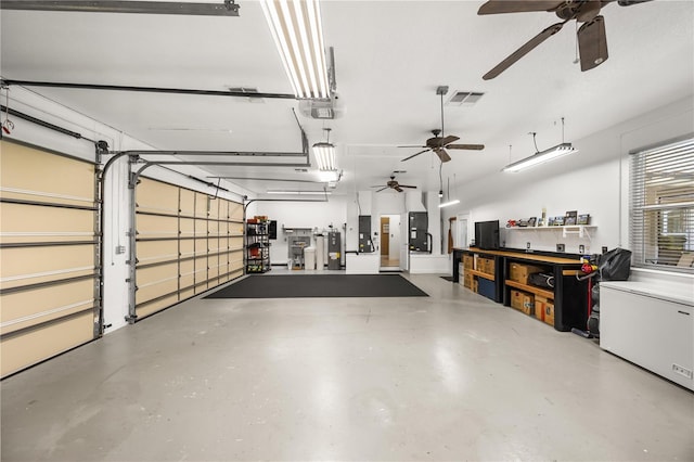 garage featuring electric water heater, visible vents, and a garage door opener