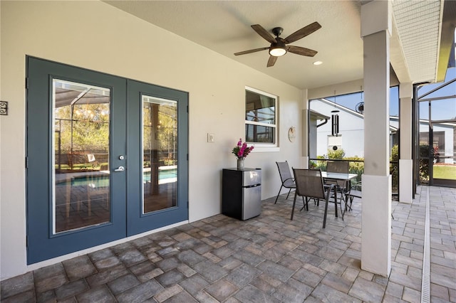 view of patio / terrace featuring ceiling fan, french doors, outdoor dining area, and a lanai