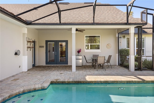 rear view of house with a patio, a ceiling fan, french doors, roof with shingles, and stucco siding