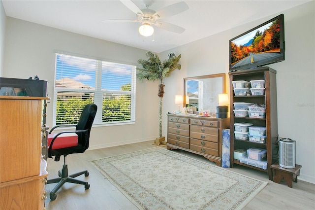 home office with wood finished floors, baseboards, and ceiling fan