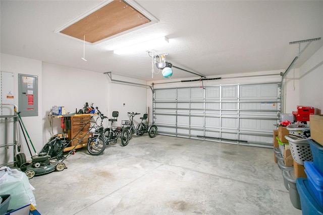 garage featuring electric panel and a garage door opener