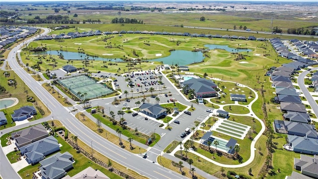 birds eye view of property with a residential view, golf course view, and a water view