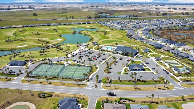 birds eye view of property featuring view of golf course, a water view, and a residential view