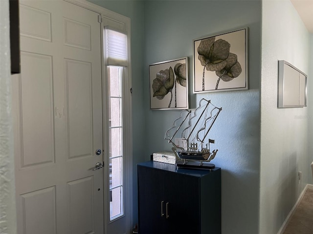 foyer entrance featuring baseboards