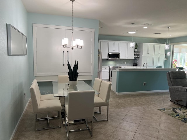 dining space with a chandelier, recessed lighting, tile patterned floors, and baseboards