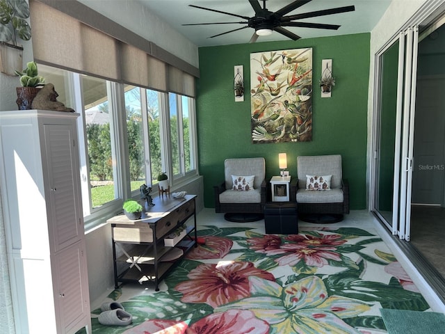 sitting room featuring ceiling fan