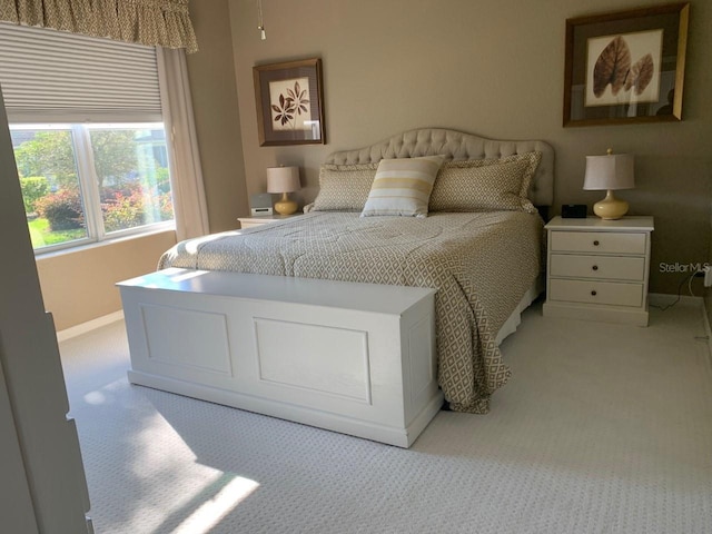 carpeted bedroom with baseboards