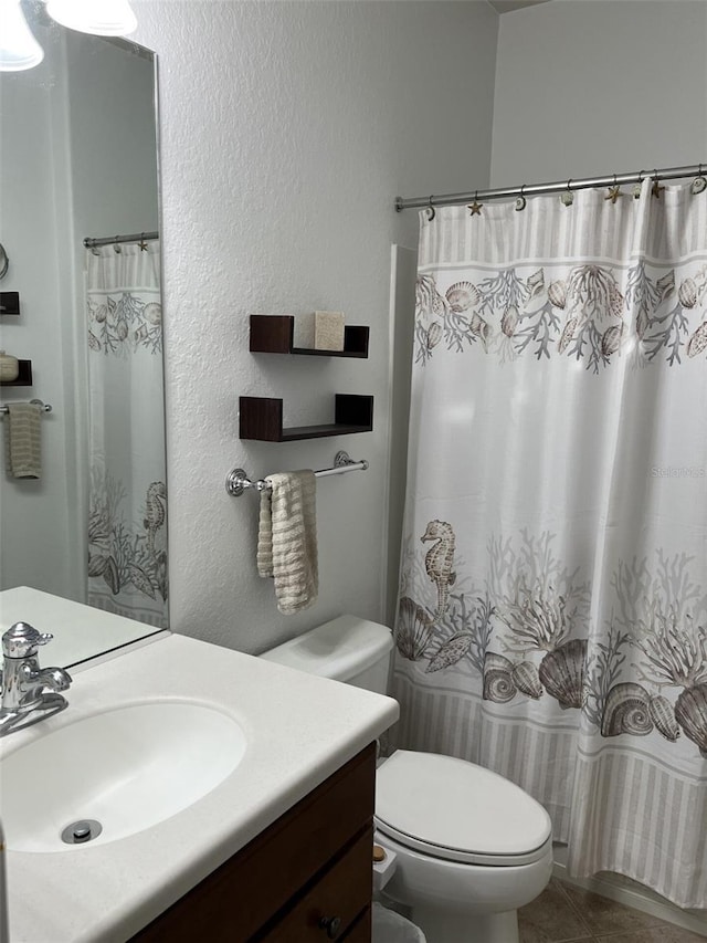 bathroom with vanity, tile patterned floors, and toilet