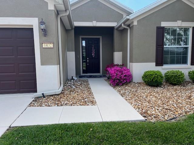 6832 SW 93rd Ave, Ocala, FL 34481 - entrance to property featuring stucco siding and an attached garage