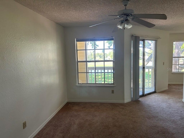 unfurnished room with a textured ceiling, baseboards, carpet flooring, and a textured wall