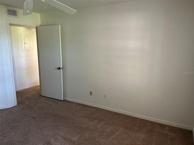 carpeted empty room featuring a textured ceiling, visible vents, and baseboards